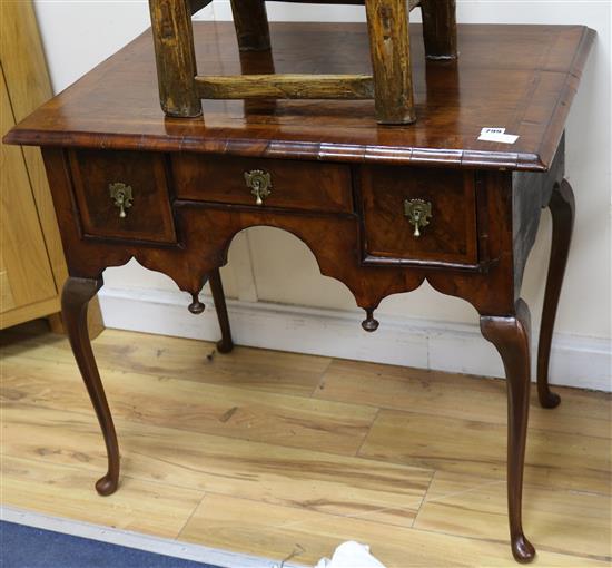 An early 18th century and later walnut and feather banded lowboy 84cm